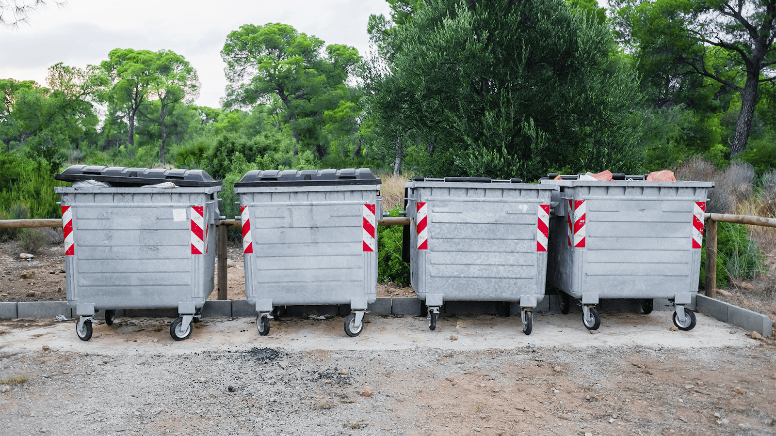 Four Dumpsters On A Road